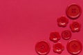 Various red sewing buttons on red background Royalty Free Stock Photo