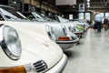 Various retro cars stand in a row
