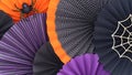 Various round paper fans in black, orange and purple colors.