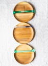 Various round wooden craft trays with resin inserts on white textile background. Top view. Copy space