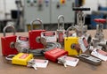 Various safety lockout padlocks and tags are displayed on a table, emphasizing lockout tagout Royalty Free Stock Photo