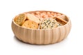 Various salty snacks in a round bowl isolated on white background Royalty Free Stock Photo