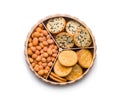Various salty snacks in a round bowl isolated on white background Royalty Free Stock Photo