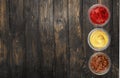 Various sauces in jars on wooden background, top Royalty Free Stock Photo