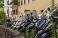 Various scooters are parked in old cozy street in Rome, Italy. A