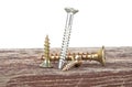 Various screws on old wooden plank on white background Royalty Free Stock Photo