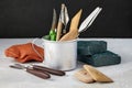 Various sculptor's tools for modeling and pieces of clay and plasticine on a light table with a dark backdrop Royalty Free Stock Photo