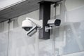 Various security cameras at office glass building exterior Royalty Free Stock Photo