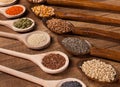 Various seeds and grains in wooden spoons