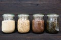 Various seeds in storage jars in pantry, dark wooden background. Smart kitchen organization Royalty Free Stock Photo