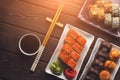Various sets of sushi rolls in ceramic plates on wooden table, top view Royalty Free Stock Photo