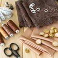 Satin fabric, lace and tailoring tools on wooden background Royalty Free Stock Photo