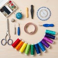 Various sewing tools are neatly arranged on a wooden surface. Items include a set of Royalty Free Stock Photo