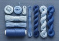 Various shades of blue thread, yarn, and embroidery floss are neatly arranged on a denim fabric Royalty Free Stock Photo