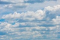 Various shape fluffy cummulus clouds accumulating on blue summer sky