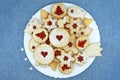 Various shapes of Linzer cookies filled with strawberry jam on a plate Royalty Free Stock Photo