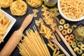 Various shapes of raw pasta on black background Royalty Free Stock Photo