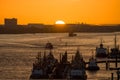 Various ships in a harbor at sunset Royalty Free Stock Photo