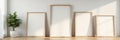 Various sized empty wooden frames against a sleek modern wall, wooden, image, wall art Royalty Free Stock Photo