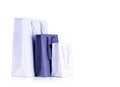 Various sizes of holiday shopping gift bags color very peri lavender on isolated white background