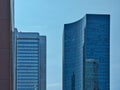 Various skyscrapers with glass fronts and associated reflections with a clear sky Royalty Free Stock Photo