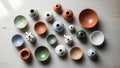 Various small ceramic pottery pieces are displayed on a light wooden surface Royalty Free Stock Photo