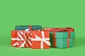 Various small Christmas gift boxes on green background Royalty Free Stock Photo