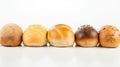 Various small fresh buns with a sprinkle of seeds in a row, white background isolate. AI generated.