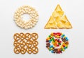 Various snacks arranged in geometric shapes on a white background Royalty Free Stock Photo