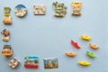 Various souvenir magnets and paper ships arranged on the blue background