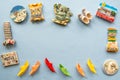 Various souvenir magnets and paper ships arranged on the blue background