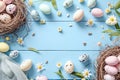 Various speckled Easter eggs in nests with daisies on a blue wooden background, a festive spring setting. Royalty Free Stock Photo