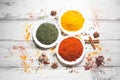 Various spices in a bowls on white wooden background. Top view with copy space. Cooking ingredients and condiments concept Royalty Free Stock Photo