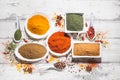 Various spices in a bowls on white wooden background. Top view with copy space. Cooking ingredients and condiments concept Royalty Free Stock Photo