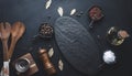 Various spices and an empty black board on the table. Salt, pepper and olive oil Royalty Free Stock Photo