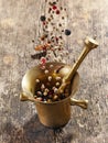 Various spices falling into mortar and pestle Royalty Free Stock Photo