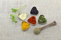 Various spices in heart chaped containers and a spoon Royalty Free Stock Photo