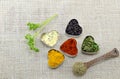 Various spices in heart chaped containers on a tablecloth Royalty Free Stock Photo
