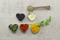 Various spices in heart chaped containers on a tablecloth Royalty Free Stock Photo