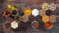 Spices in hexagonal jars on a wooden surface