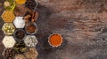 Spices in hexagonal jars on a wooden surface