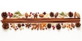 Various spices and nuts arranged on a white surface.