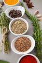Various spices and spicy herbs close-up on a light gray table. Royalty Free Stock Photo