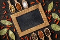 Various spices in wooden spoons on dark stone table Royalty Free Stock Photo