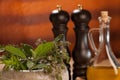 Various spices on a wooden table with mortar, pestle and mills. Royalty Free Stock Photo