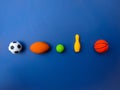 various sports balls on blue background