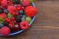 Various summer Fresh berries in a bowl on rustic wooden table. Antioxidants, detox diet, organic fruits. Berries Royalty Free Stock Photo