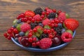 Various summer Fresh berries in a bowl on rustic wooden table. Antioxidants, detox diet, organic fruits. Berries Royalty Free Stock Photo