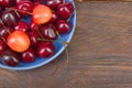 Various summer Fresh Cherry in a bowl on rustic wooden table. Antioxidants, detox diet, organic fruits. Berries Royalty Free Stock Photo