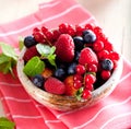 Various summer fruits in a bowl. Assorted fresh berries with lea Royalty Free Stock Photo